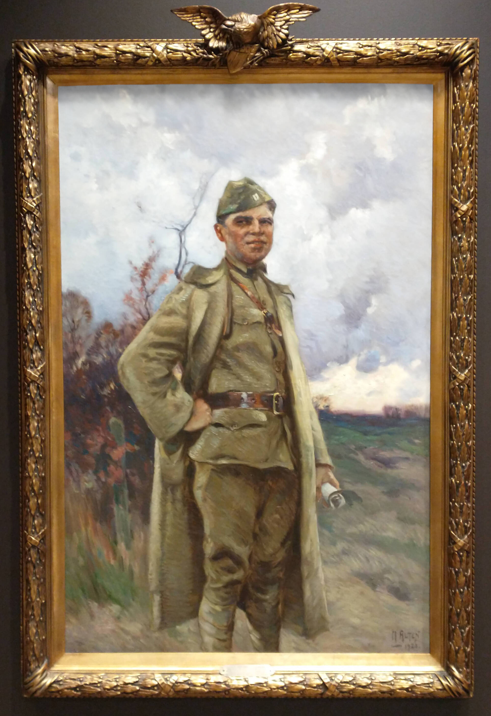 Painting of a man in a soldier's uniform in an elaborate frame with an eagle.